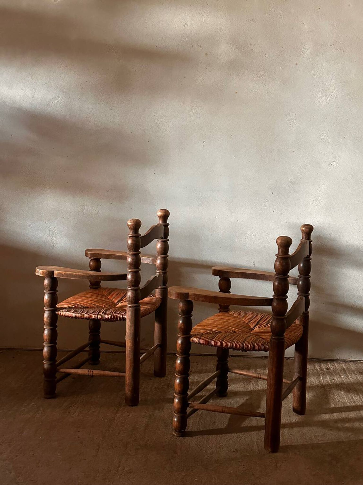 Pair of French spindle chairs in the style of Charles Dudouyt.