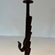 Pair of wrought iron andirons with adjustable supports and tripod feet.