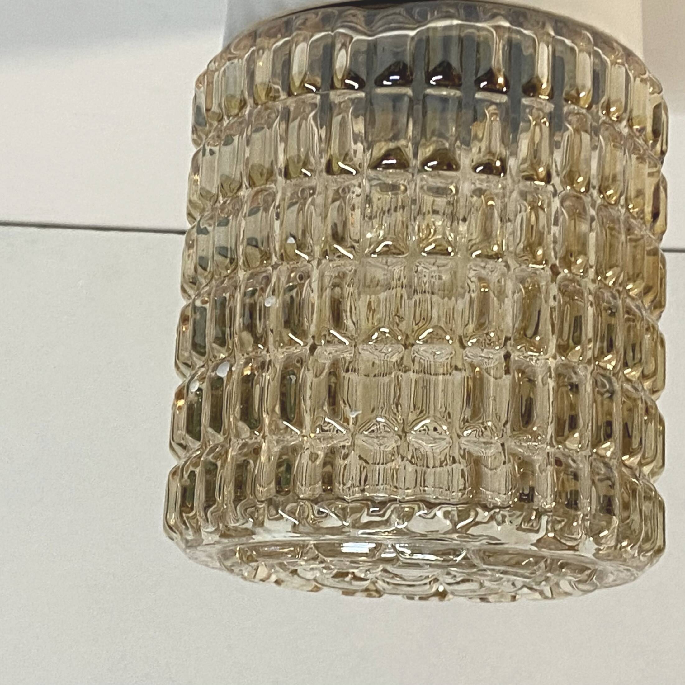 Old wall light in amber glass and plastic fixing base 1970