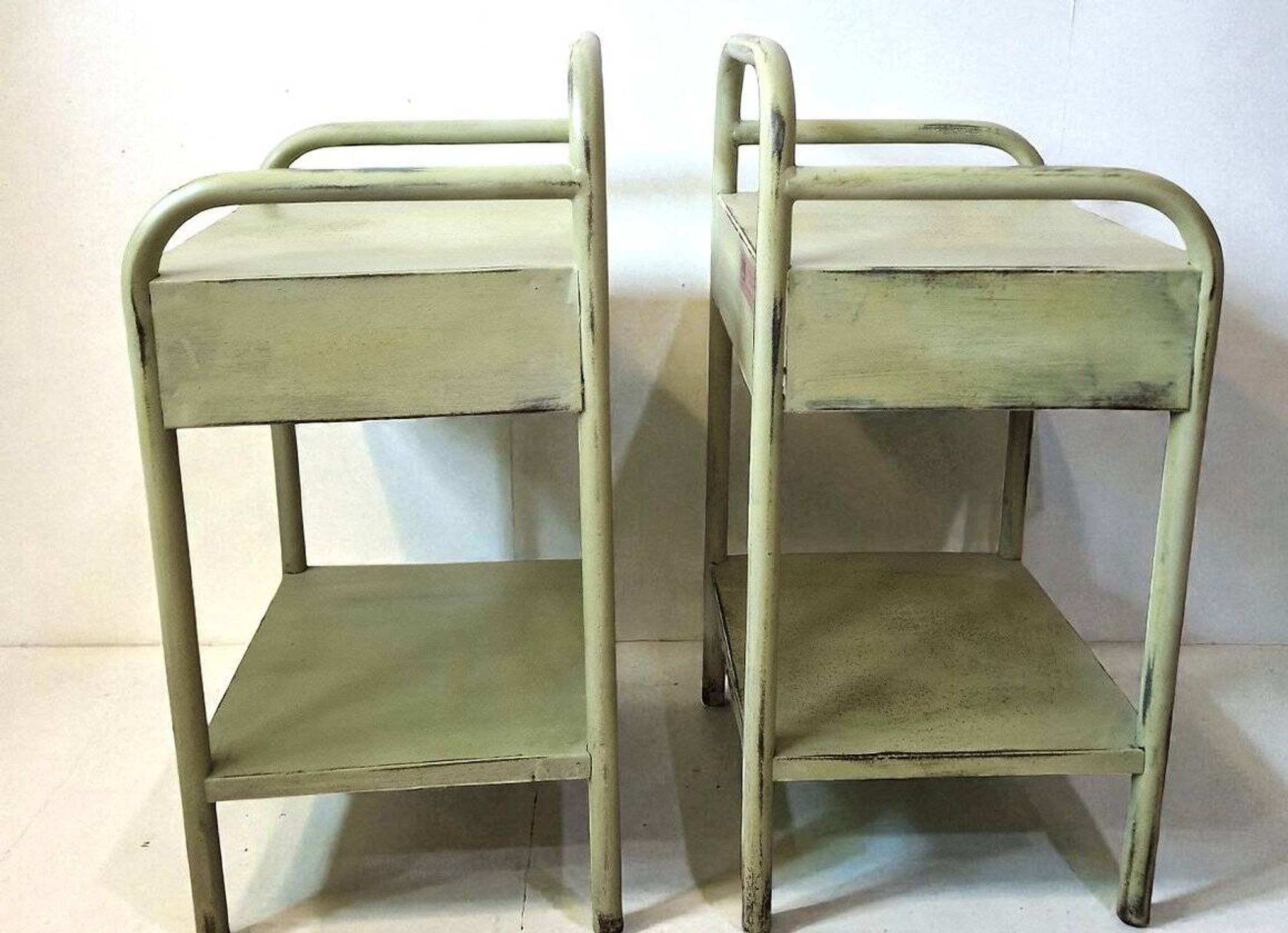 Copy of a pair of patinated metal bedside tables.