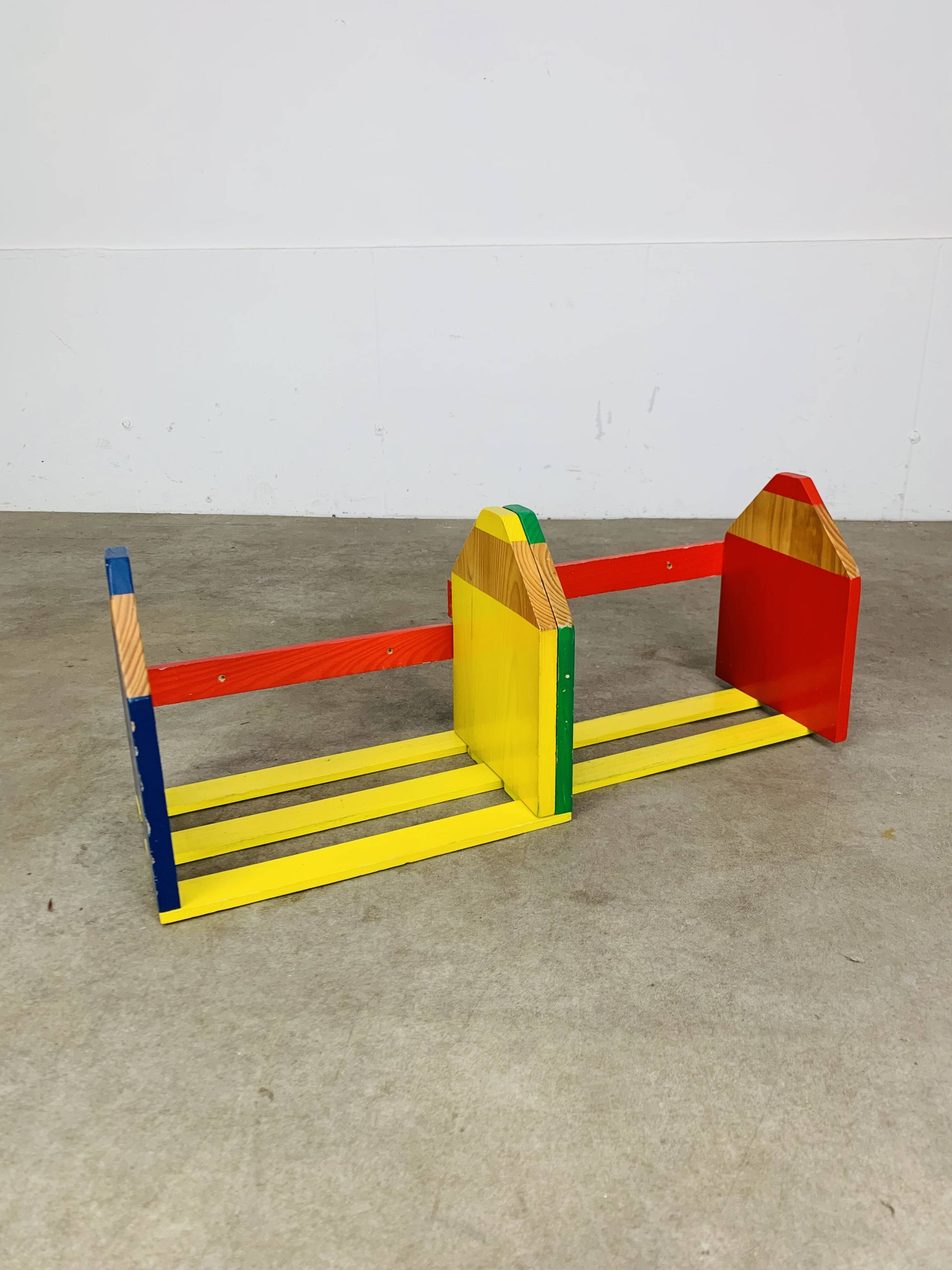 Modular wall-mounted pencil shelf in Pierre Sala style, for children.