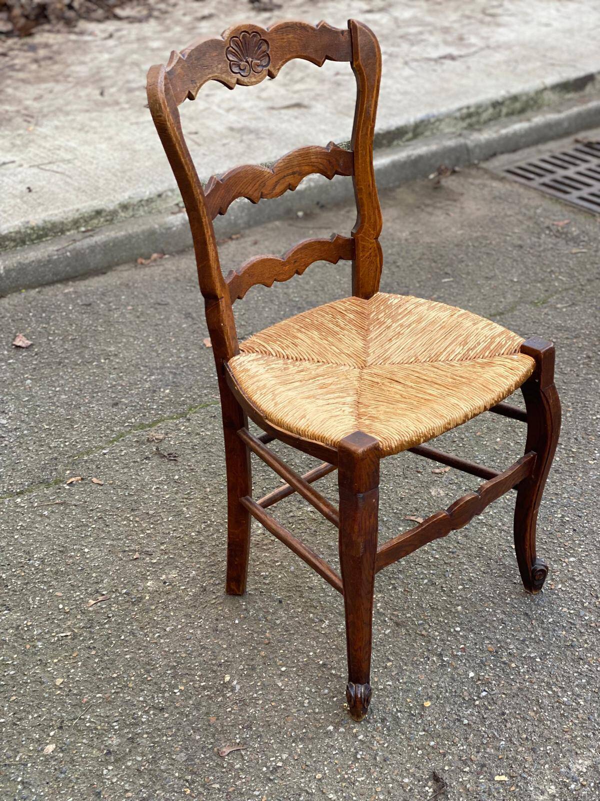 Louis XV 18th century solid wood dining chair with a straw seat.