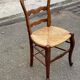 Louis XV 18th century solid wood dining chair with a straw seat.