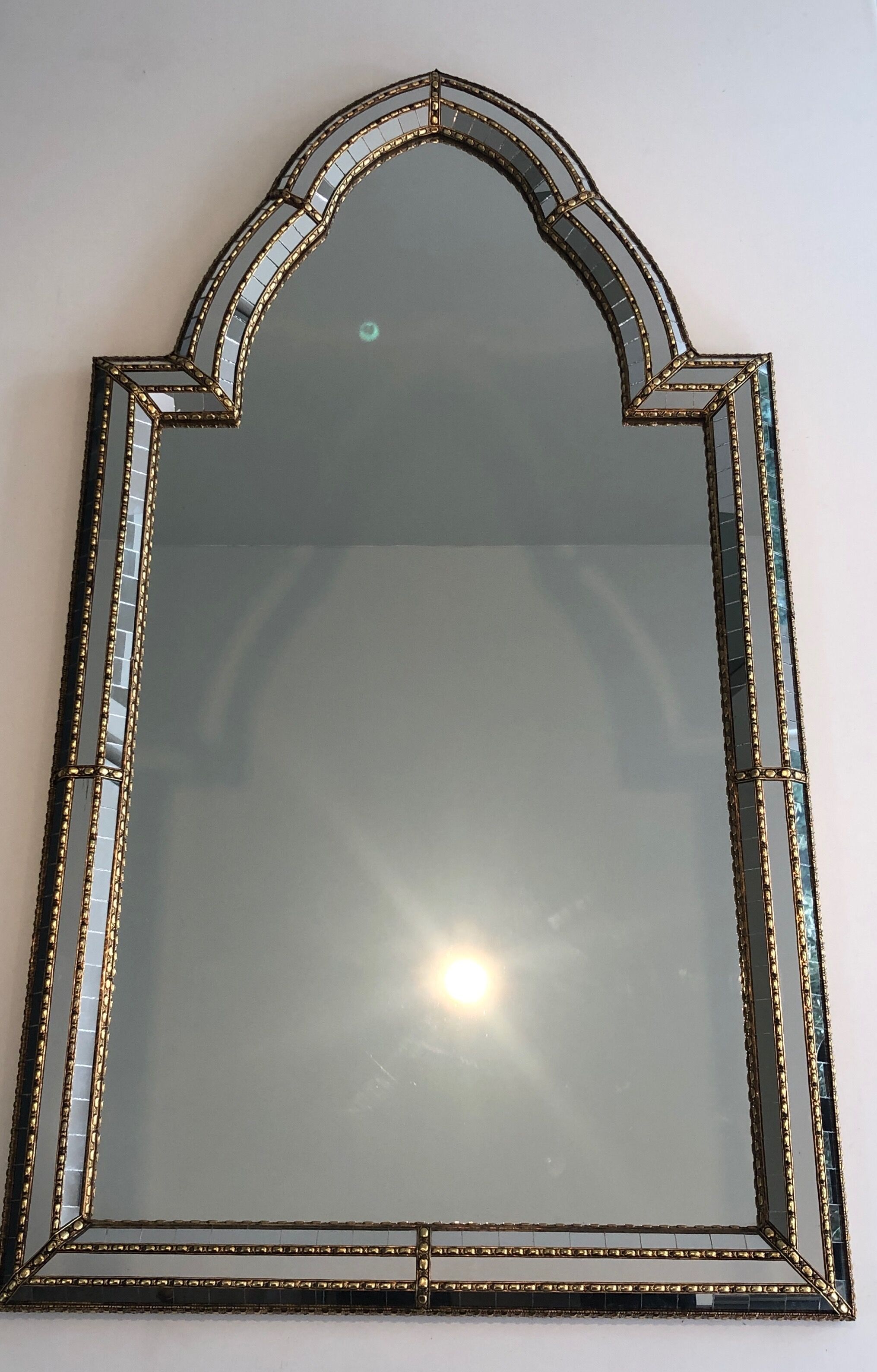 Mirror consisting of multi-faceted mirrors and brass garlands, French work, around 1970