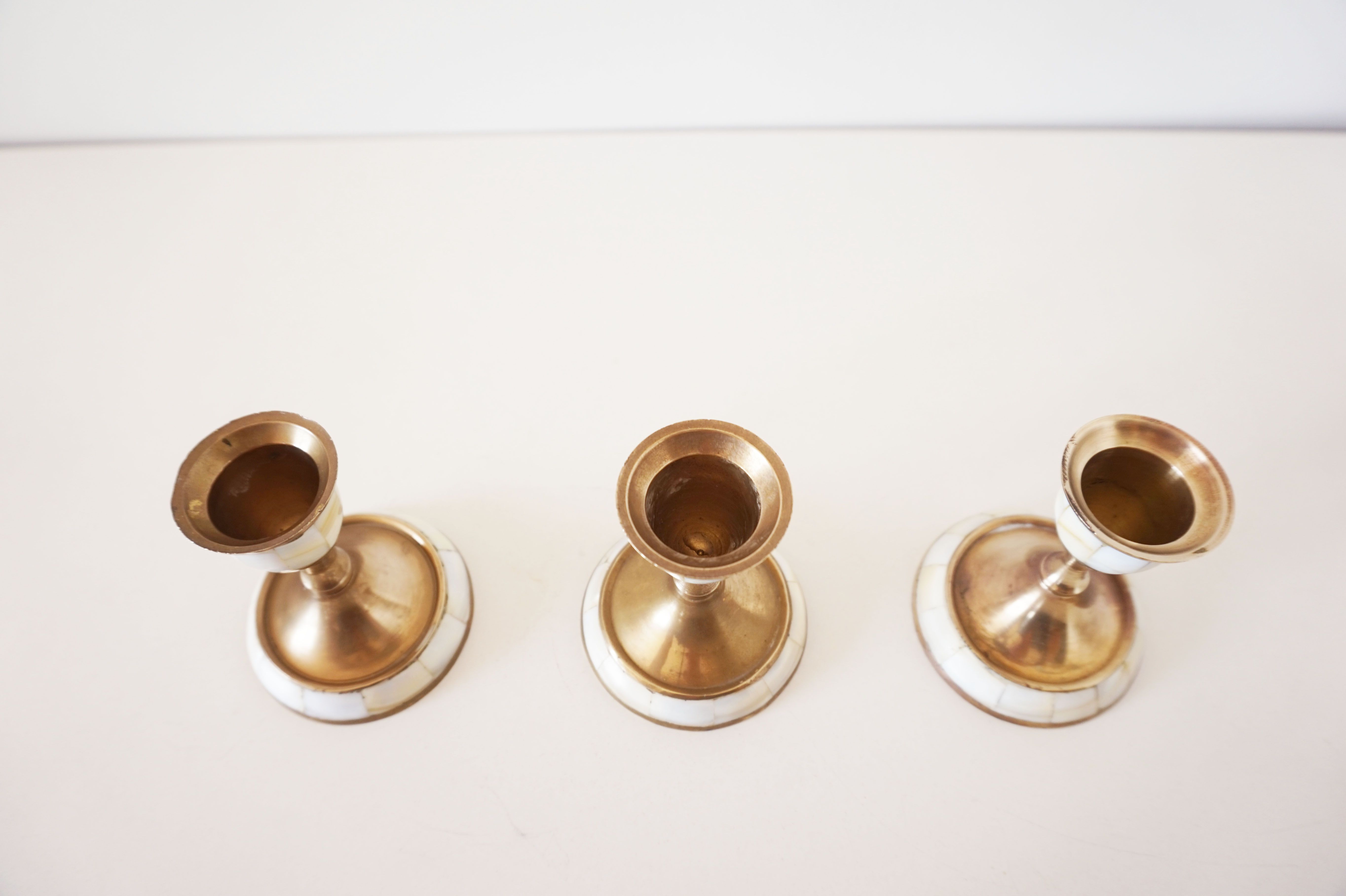 Lot of old candlesticks in brass and mother-of-pearl