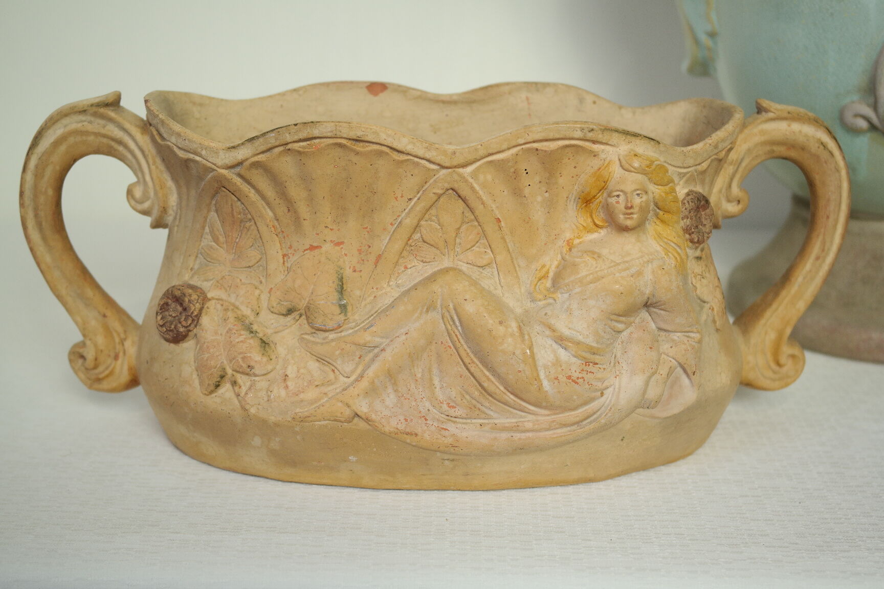 Art Nouveau jardinière with bas-reliefs in terracotta.