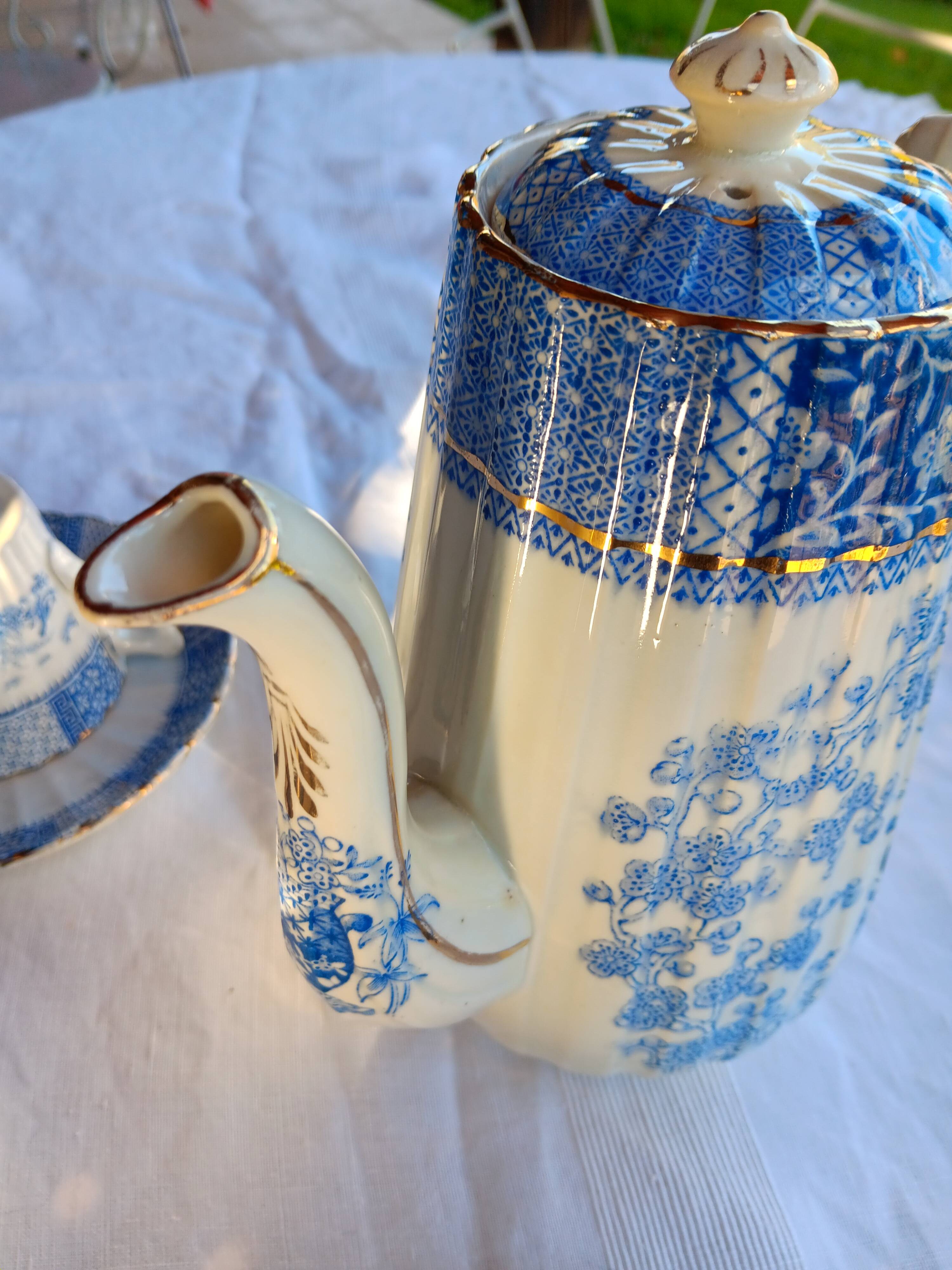 Old coffee service Lunéville with blue lace decoration.