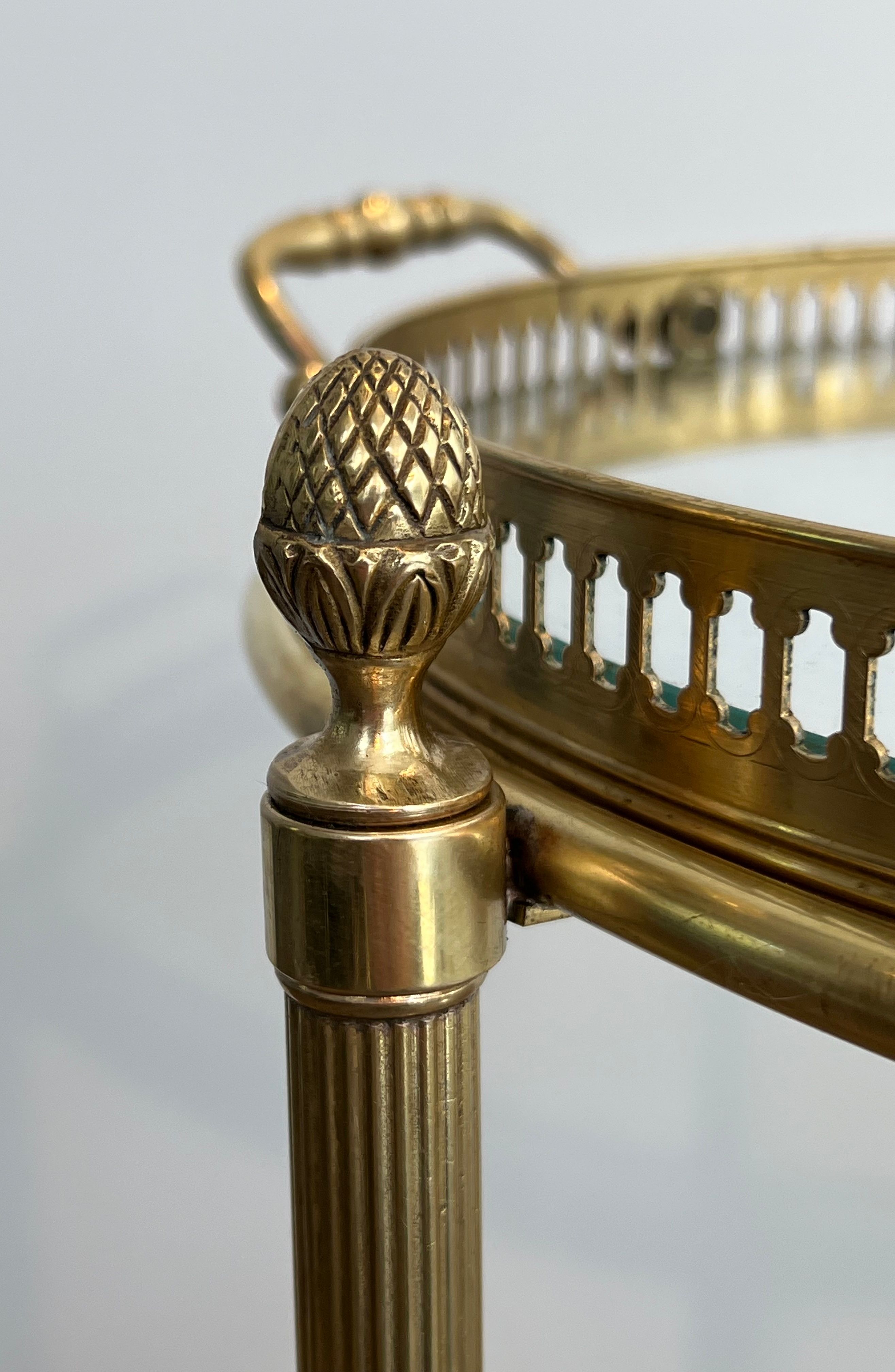 Small oval rolling table in brass with double removable trays from Maison Bagués.