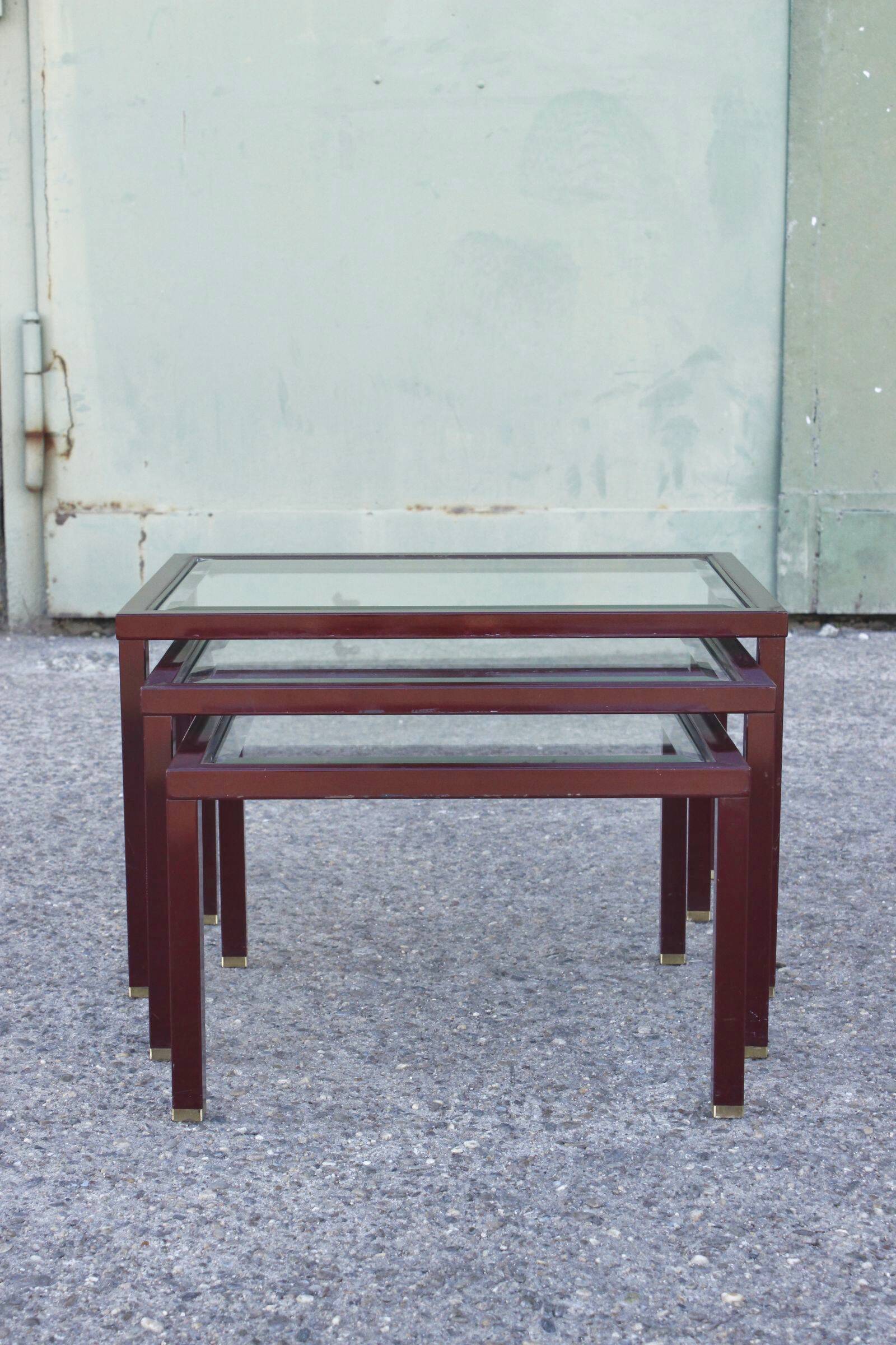 Nesting tables in burgundy lacquered metal and brass, France 1950s
