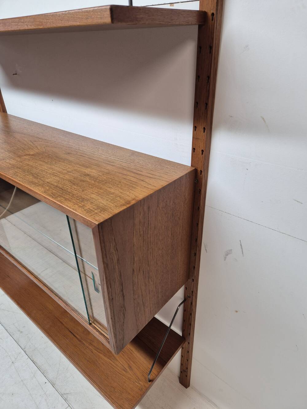 Teak shelving system with glass cabinet, marked made in Denmark, 1960.
