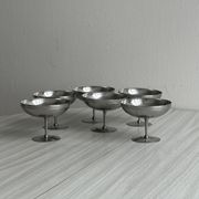 Set of 6 metal footed bowls in shiny finish.