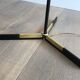 Designer floor lamp in black lacquered metal and brass