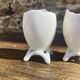 Antique porcelain egg cups in shell shape.