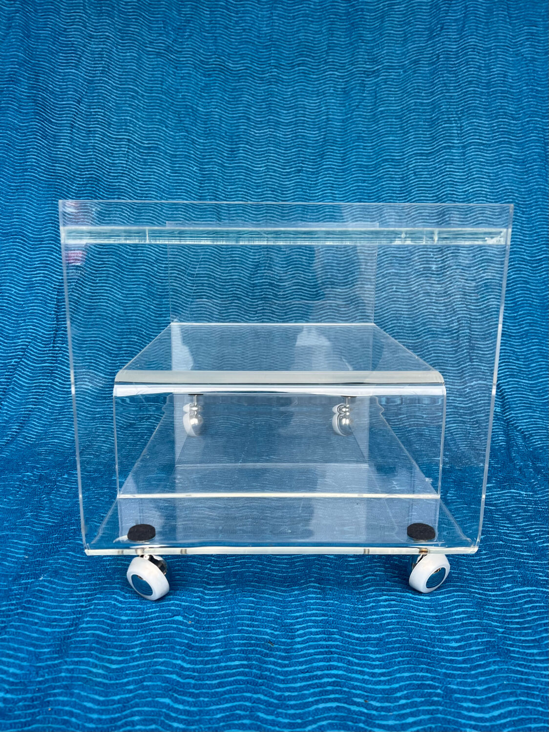 Translucent plexiglass storage drawer/cabinet on wheels.