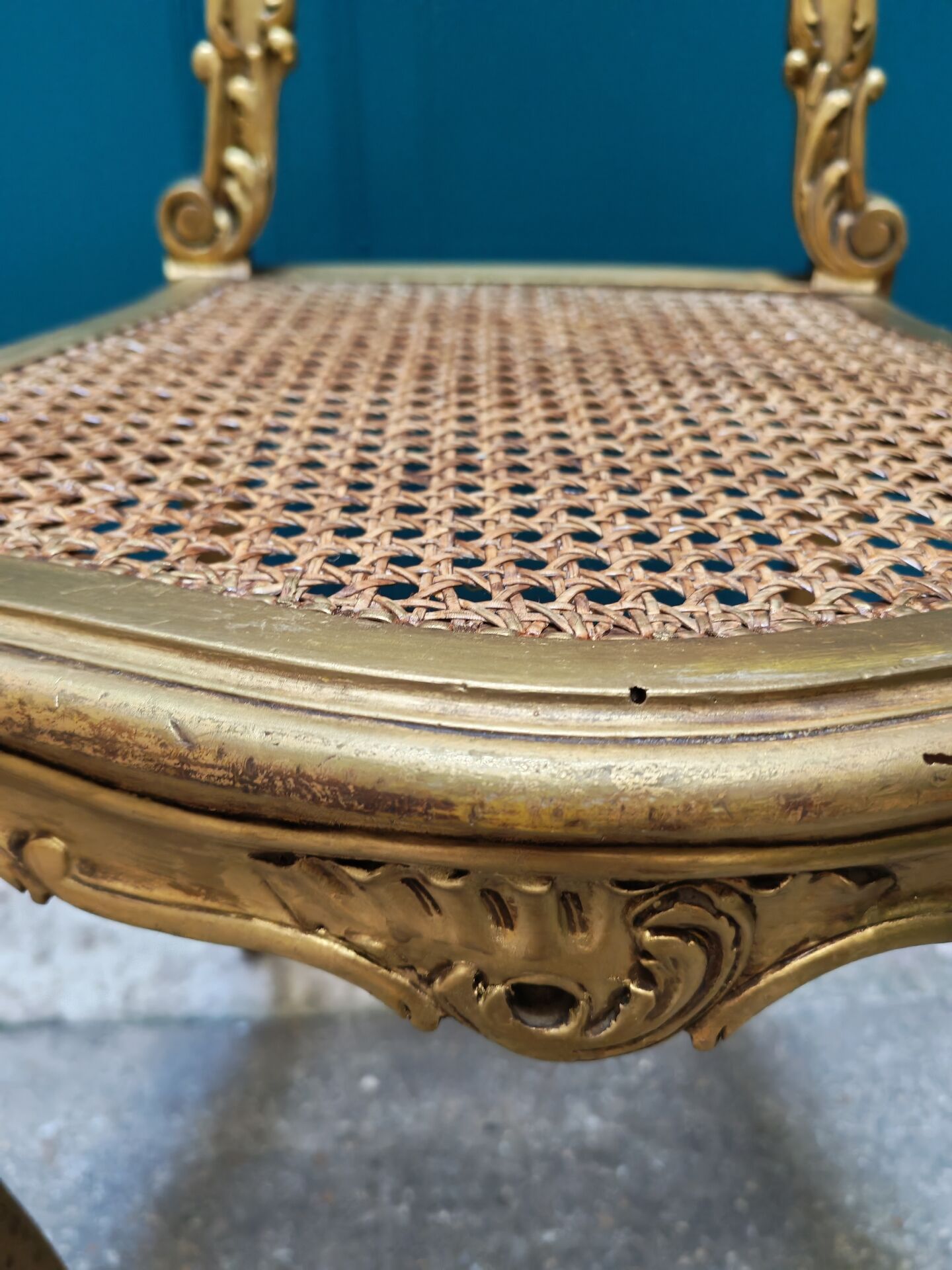 Antique rococo chair in gilded wood and caning