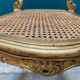 Antique rococo chair in gilded wood and caning