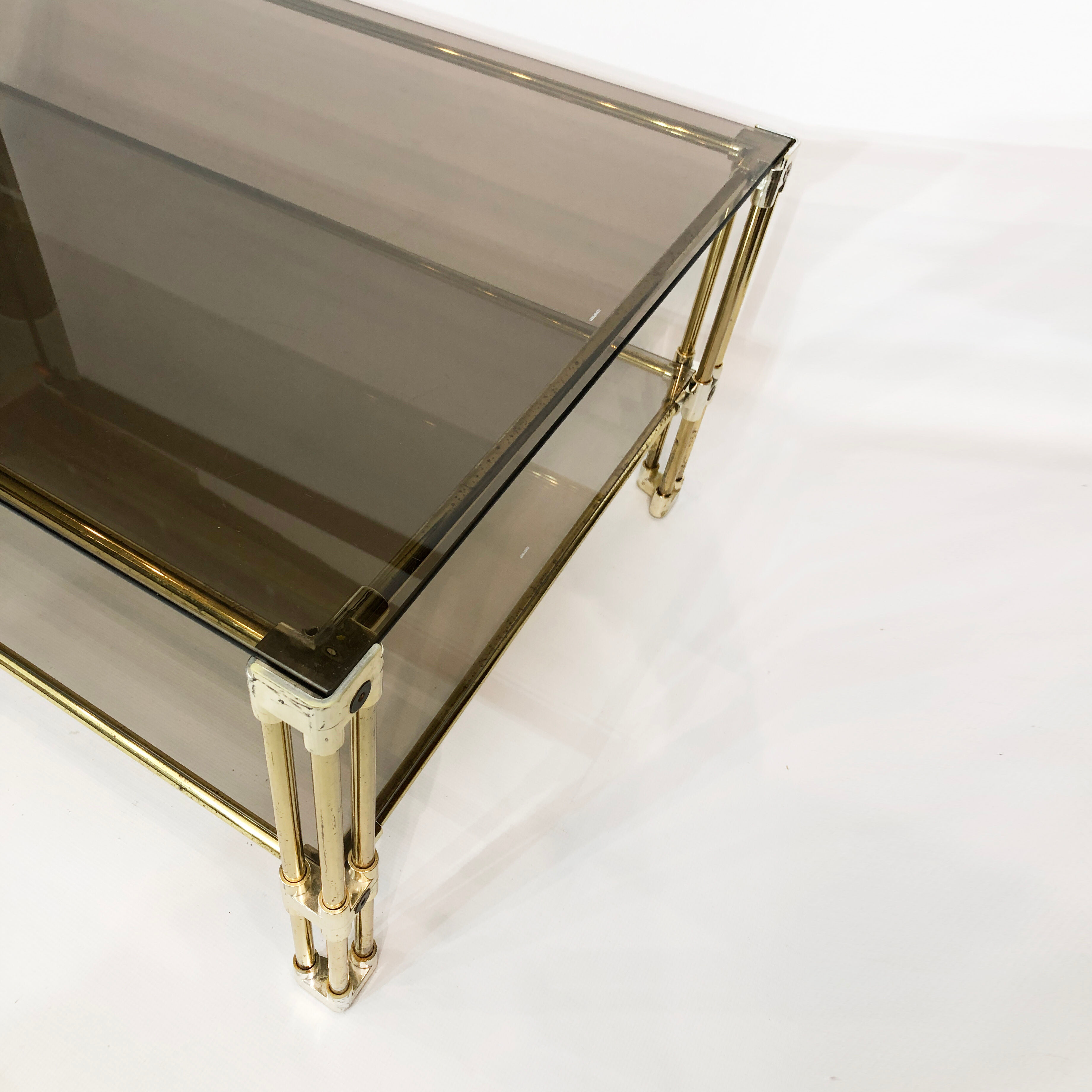 Brass two-tiered coffee table hollywood regency gold smoked glass 1970s