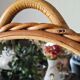 Vintage double-sided round mirror on a rattan stand.