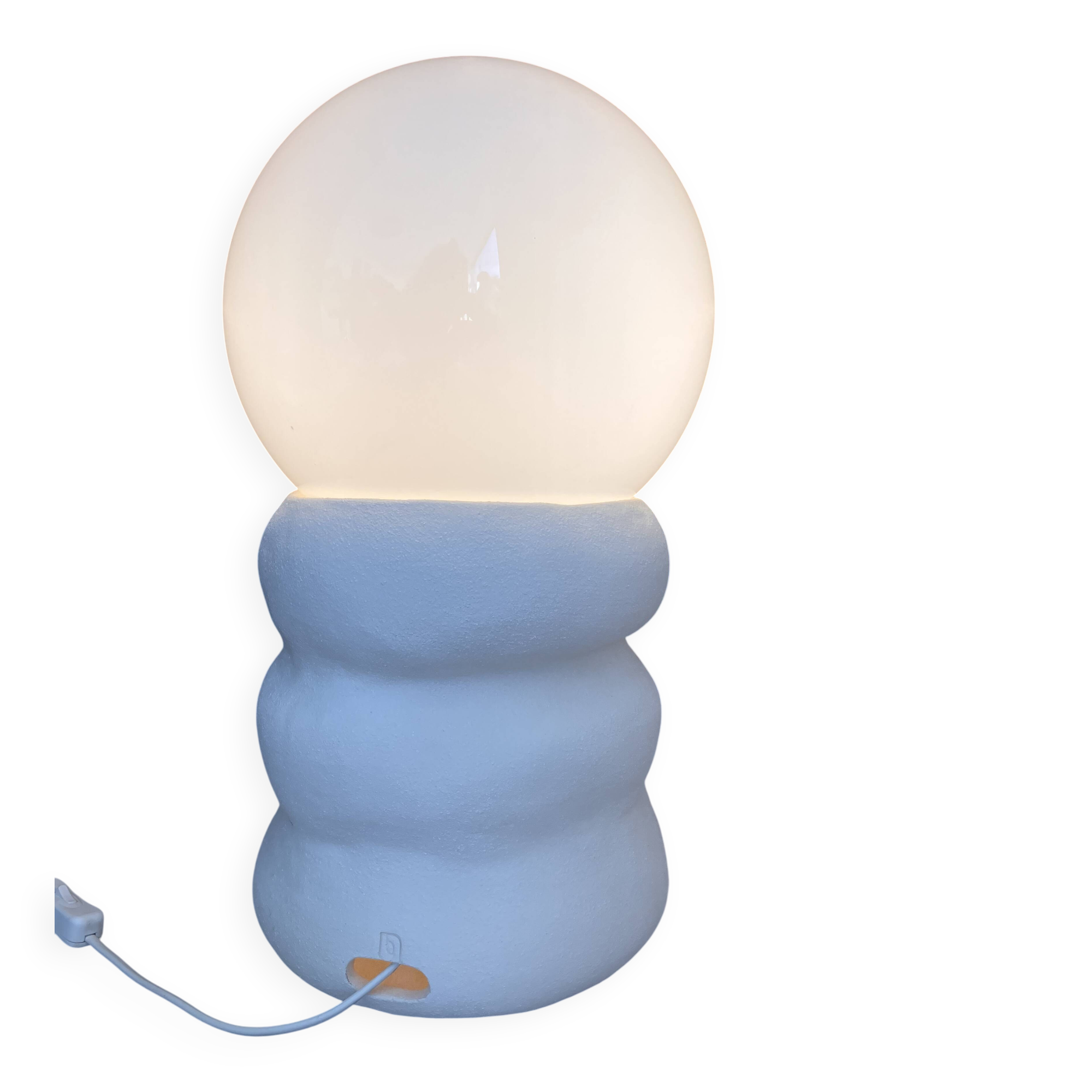 Large table lamp in off-white ceramic with an organic globe shape.