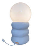 Large table lamp in off-white ceramic with an organic globe shape.