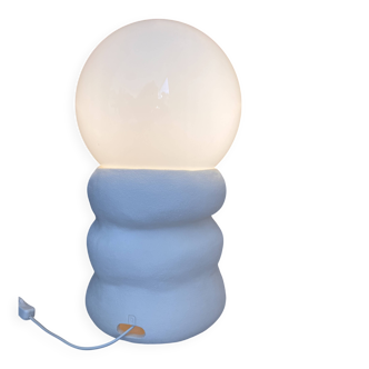 Large table lamp in off-white ceramic with an organic globe shape.