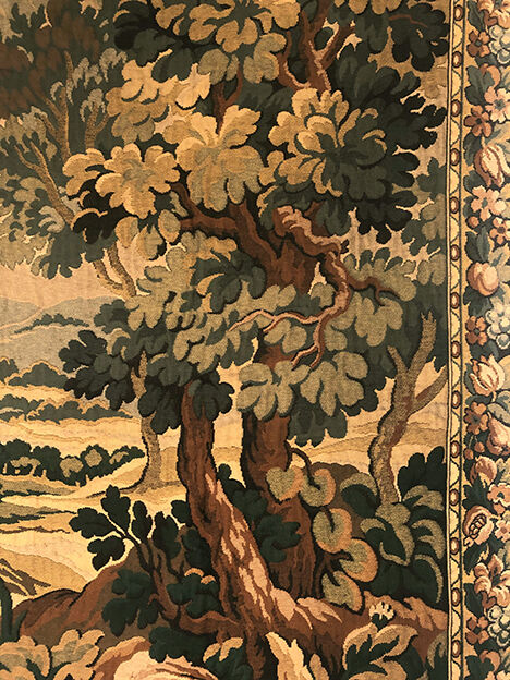Tapestry decorated with a pink flamingo in a green landscape, woven by hand