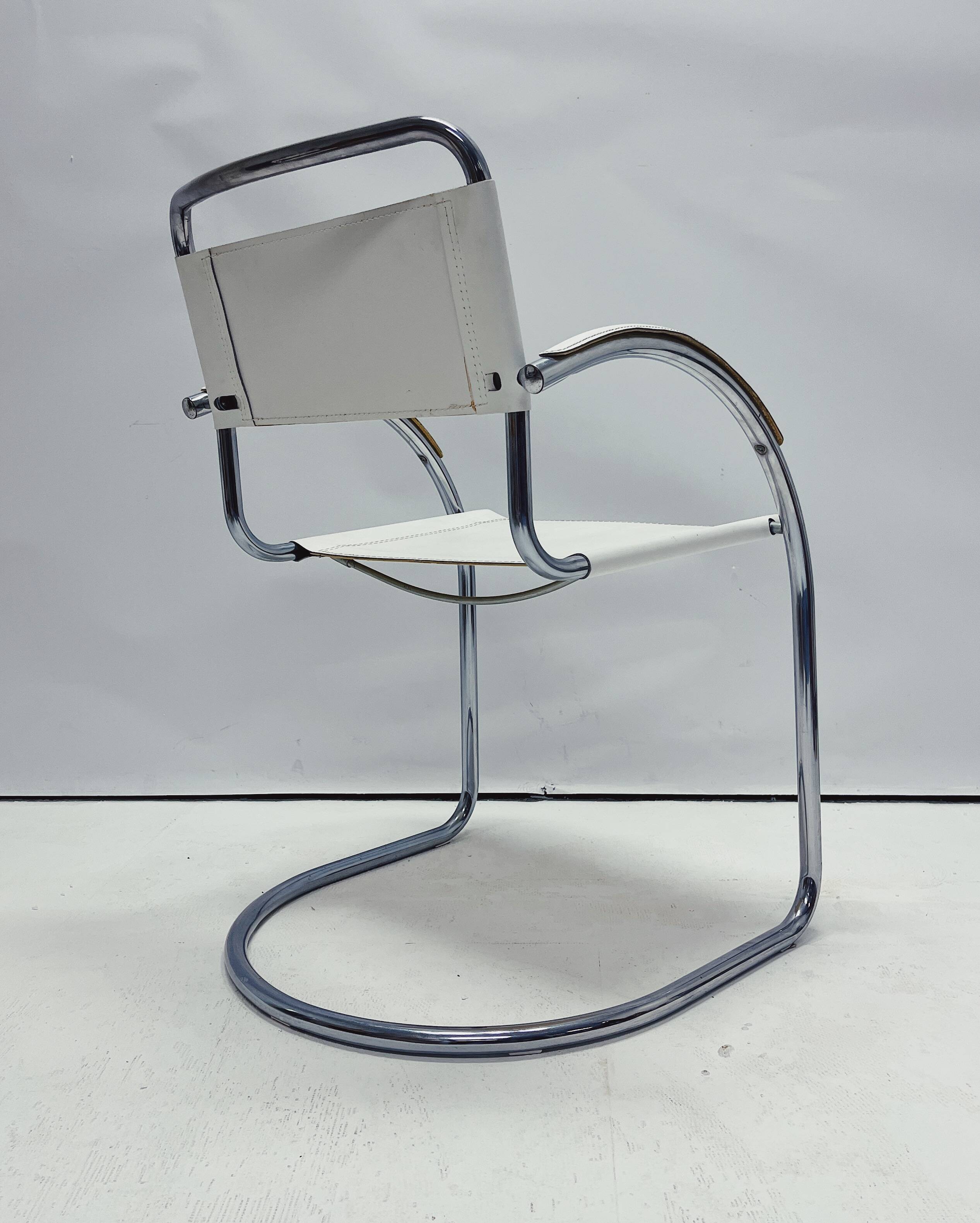 Vintage tubular frame chairs with white skai