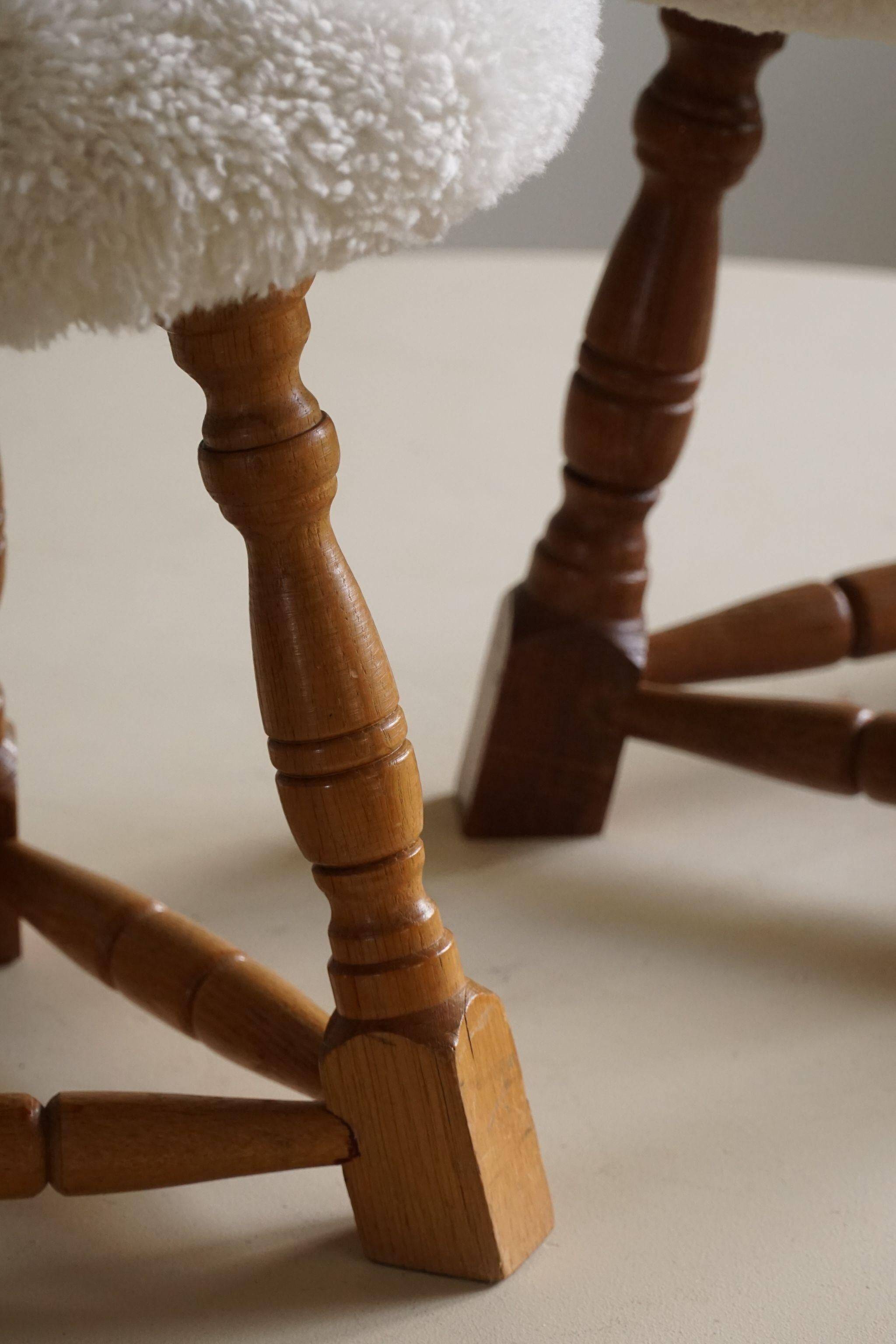 Modern Danish, a pair of tripod stools, seats reupholstered in lambswool, 1950s.