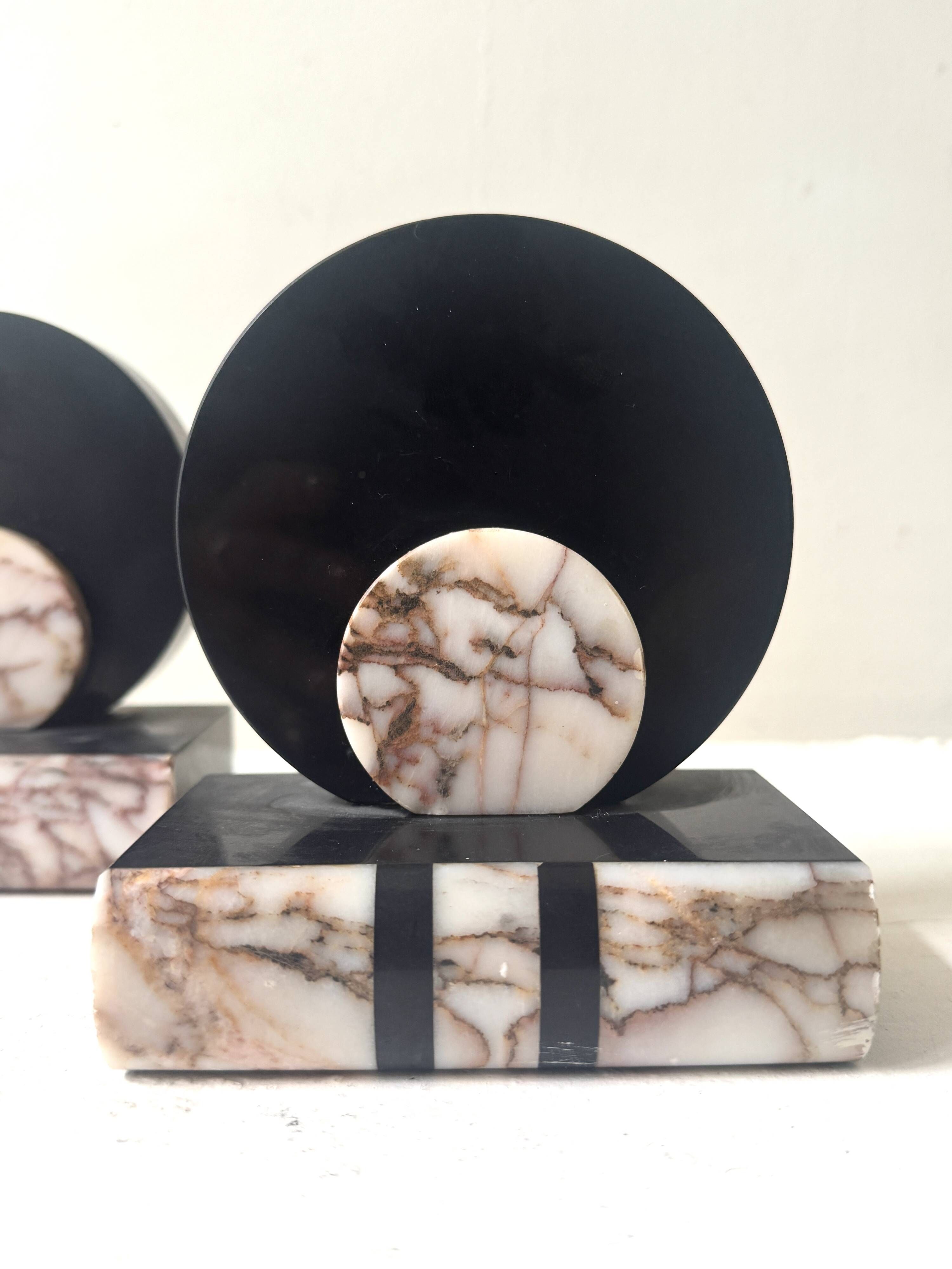 Art Deco bookends with a circular design in black and pink marble.