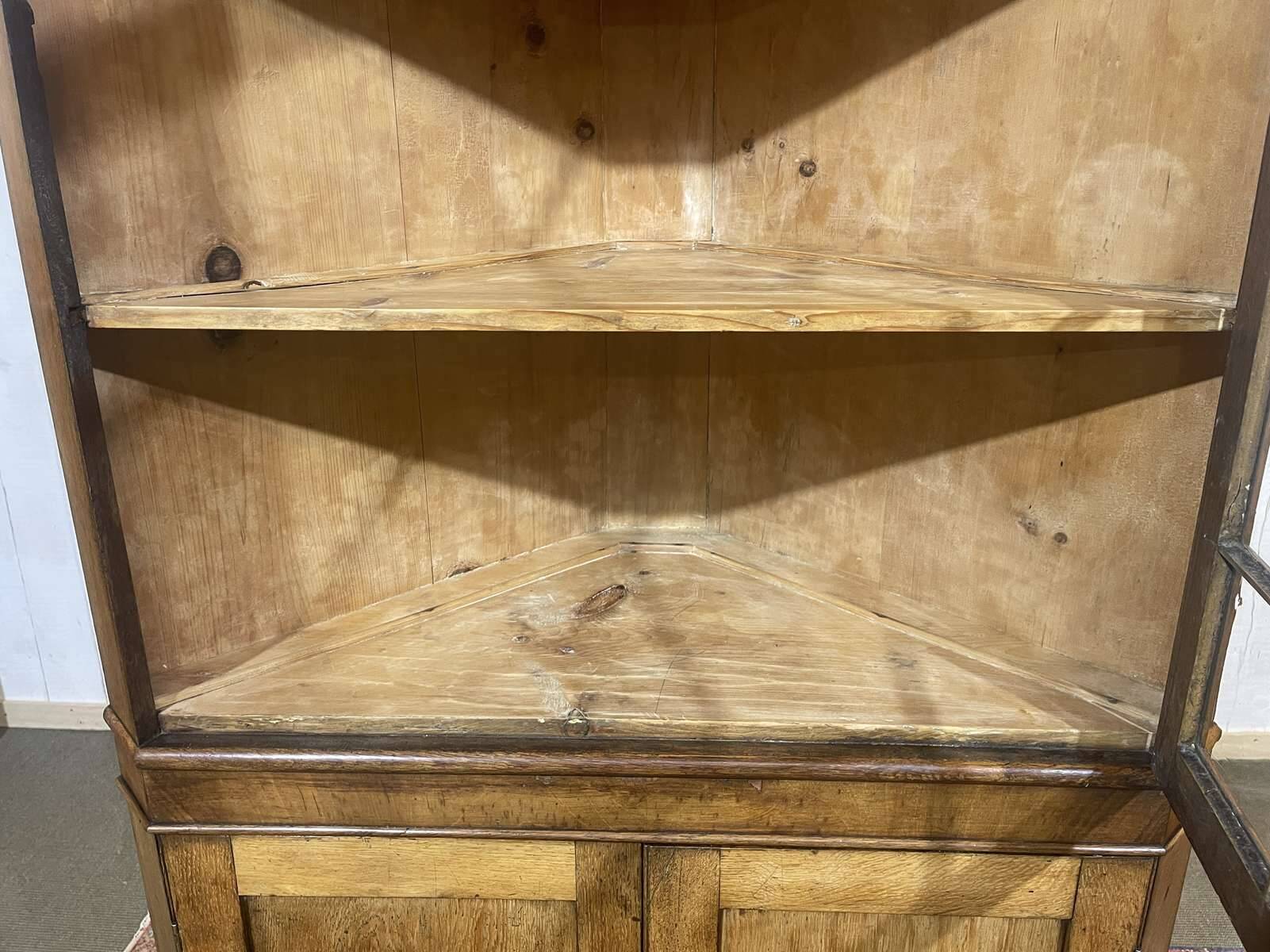 19th-century English corner cabinet in oak, mahogany, and fir.