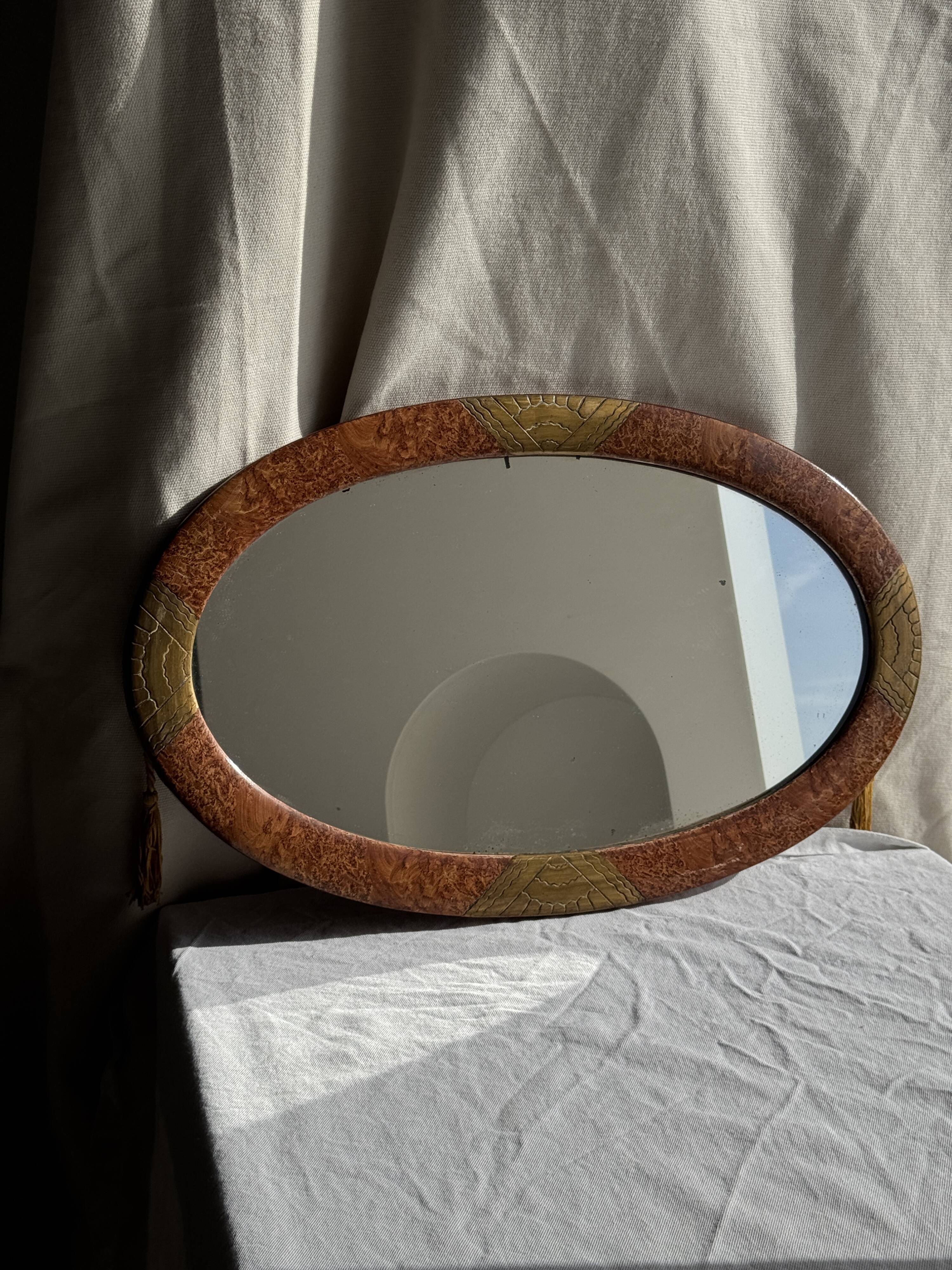 Small oval Art Deco mirror in brown and gold 33x54.
