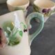10 slipware cups, pansies