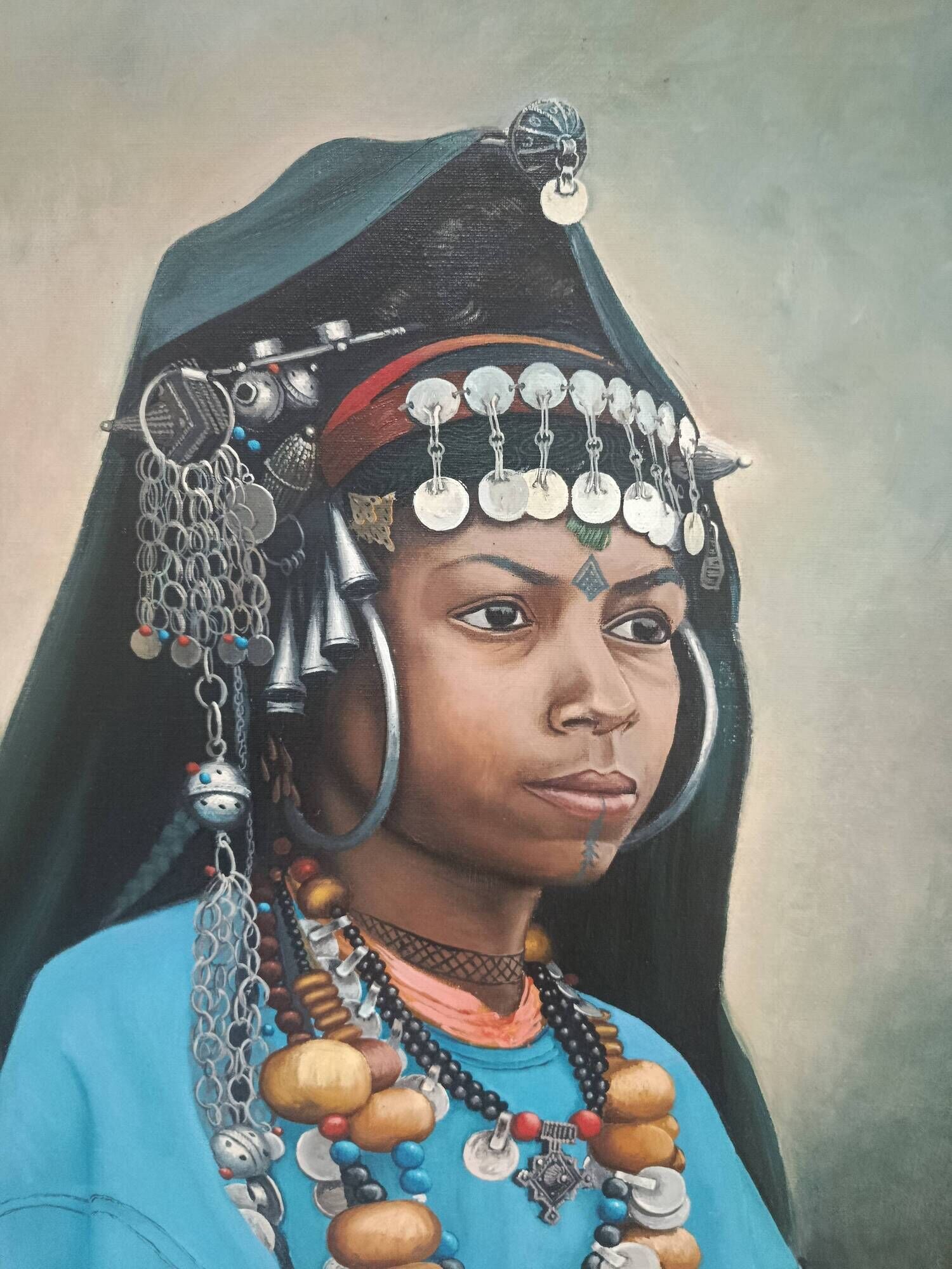 Portrait of a young Moroccan woman in traditional attire and adornments.