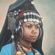 Portrait of a young Moroccan woman in traditional attire and adornments.