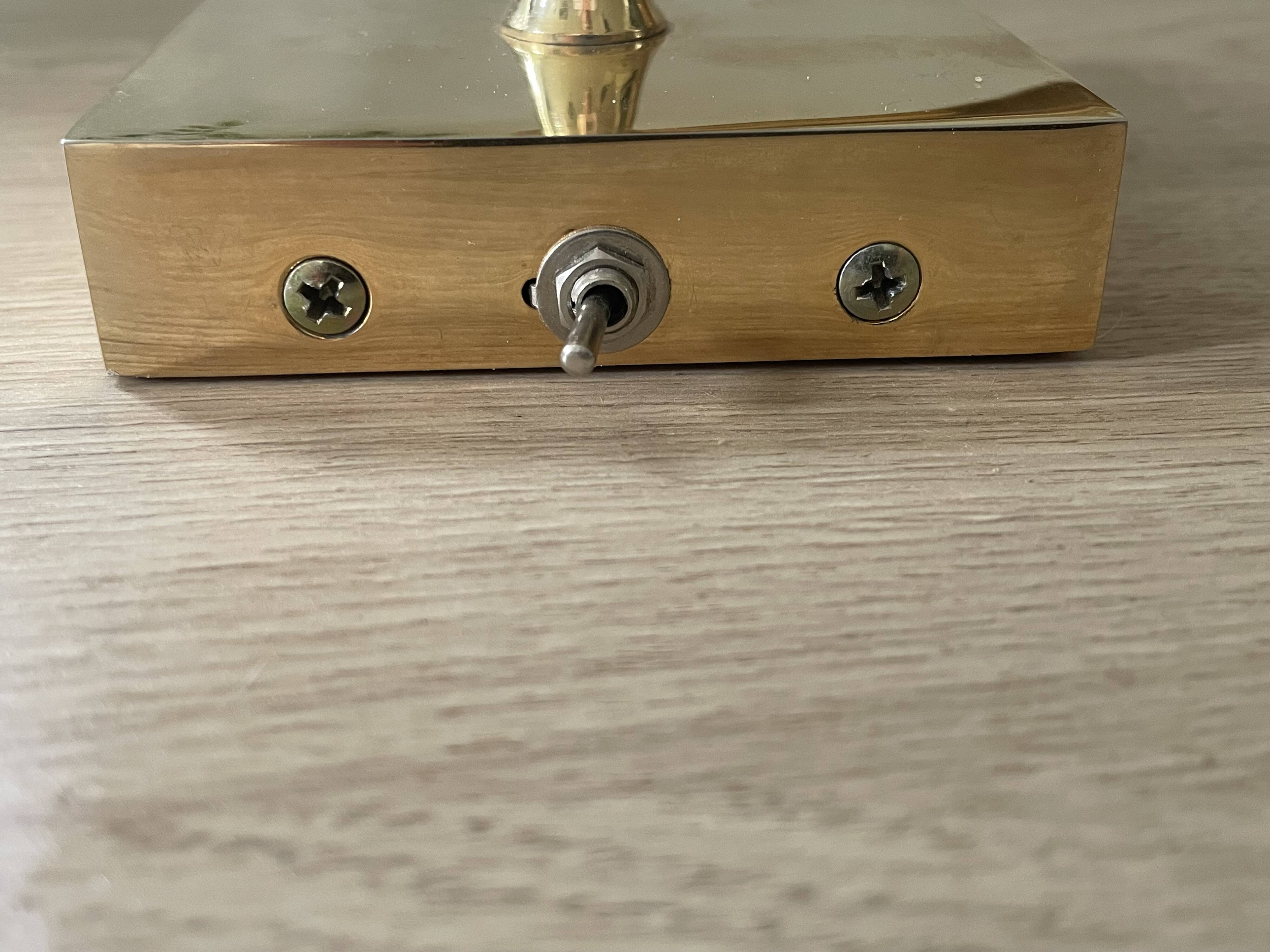 Pair of vintage brass wall lights with adjustable arms.