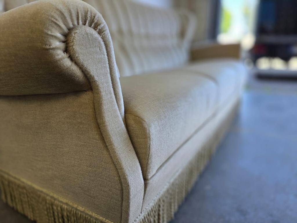 Vintage beige sofa with fringes