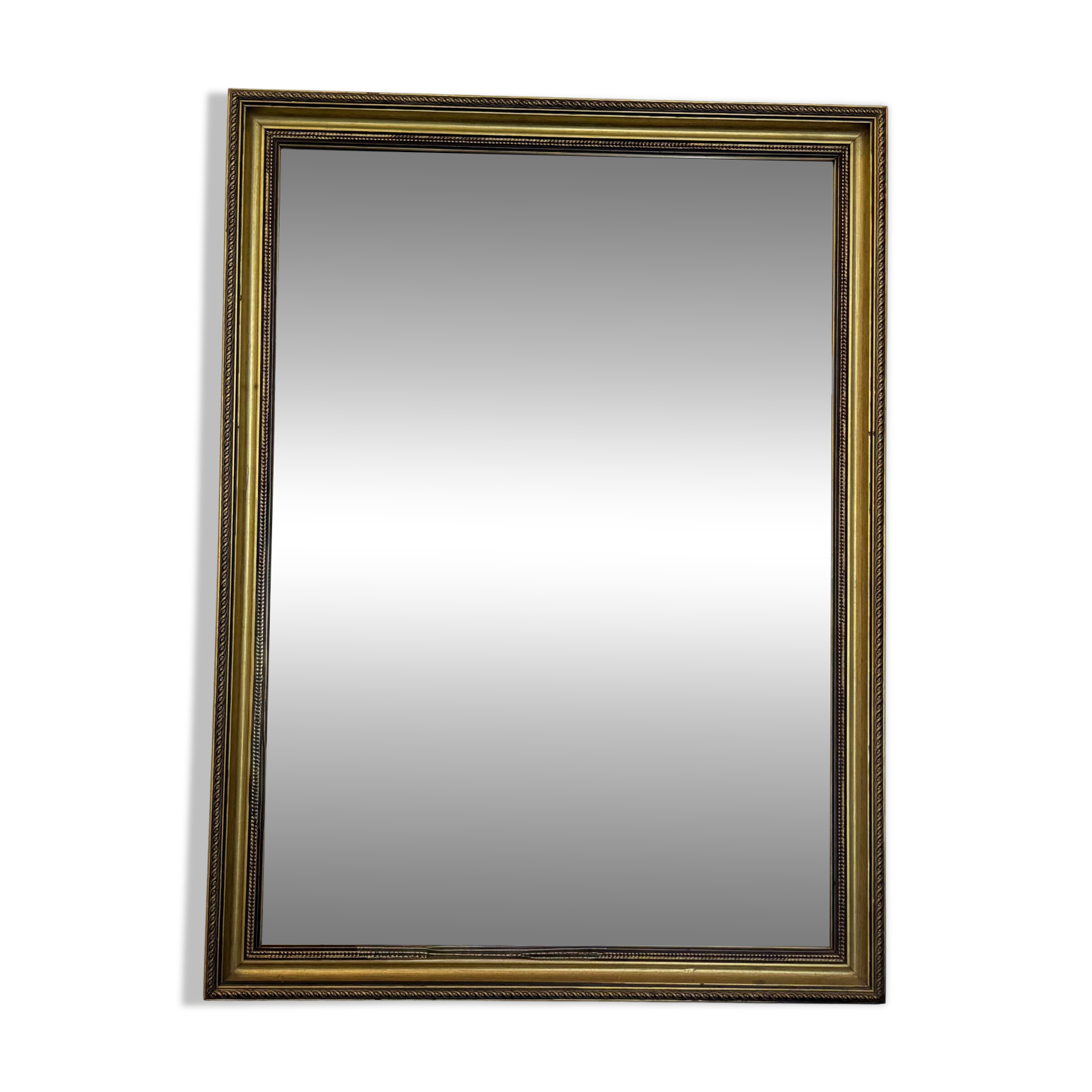 Vintage rectangular wall mirror with a golden wooden frame.