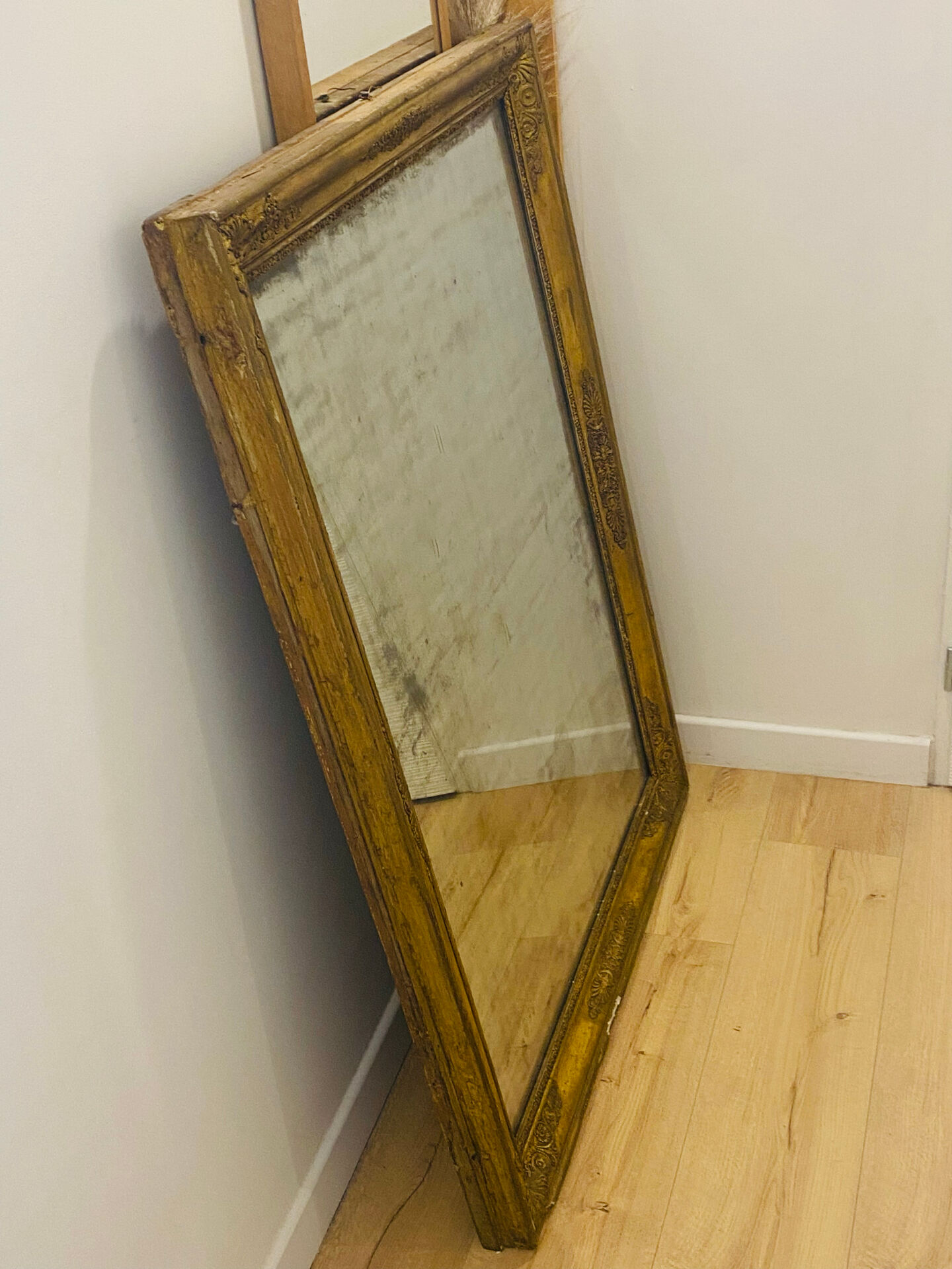 Antique mercury mirror with an Empire gold frame.