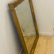 Antique mercury mirror with an Empire gold frame.