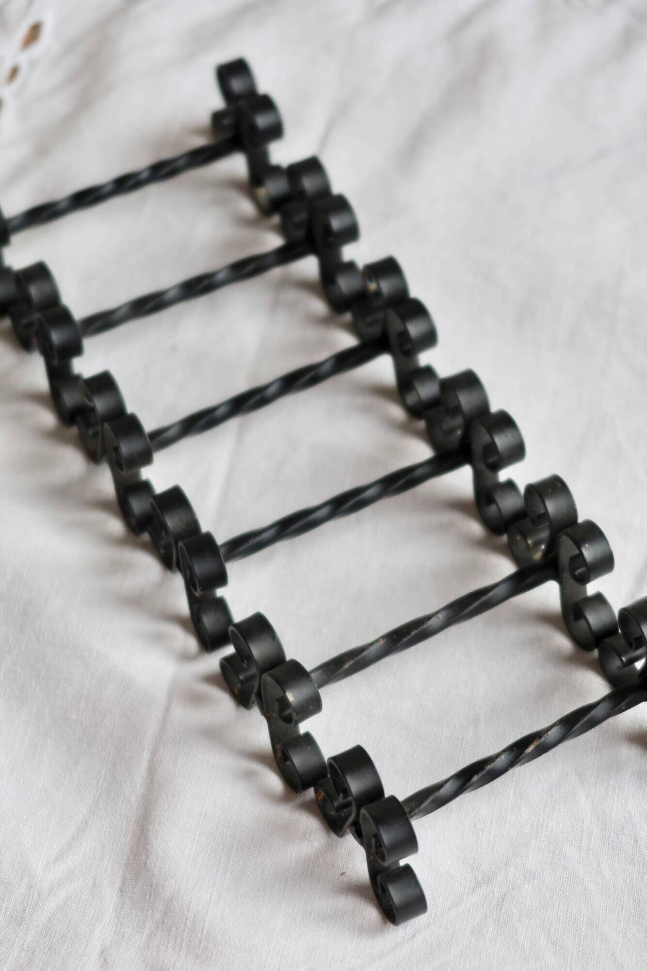 6 vintage black metal knife rests with scroll decorations