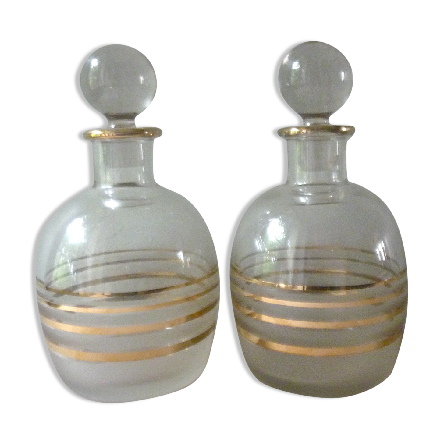 Pair of glass whiskey decanters with gold edging