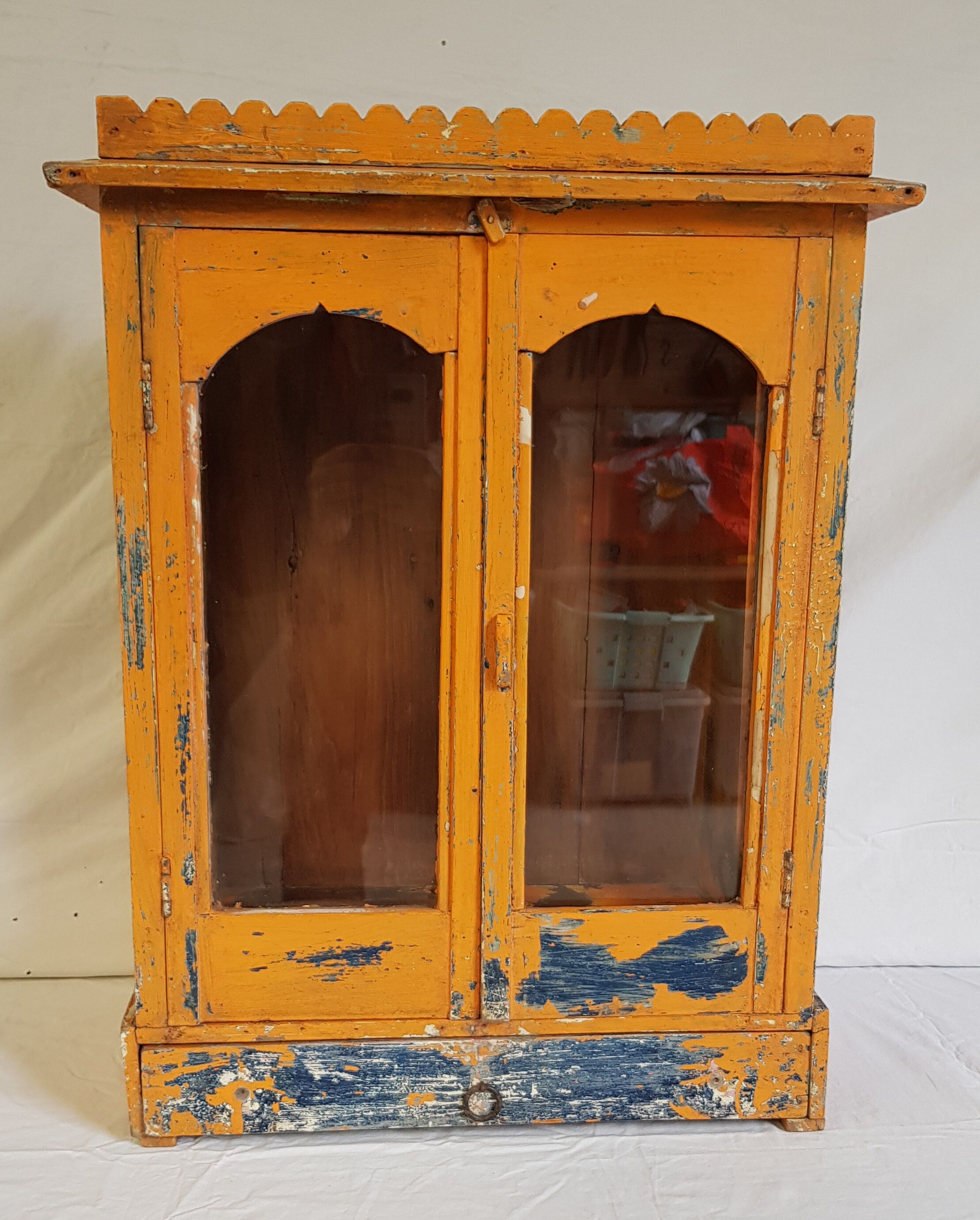 Old temple-showcase with teak offerings