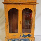 Old temple-showcase with teak offerings