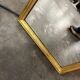 Narrow and tall antique mirror, adorned with golden patterns.