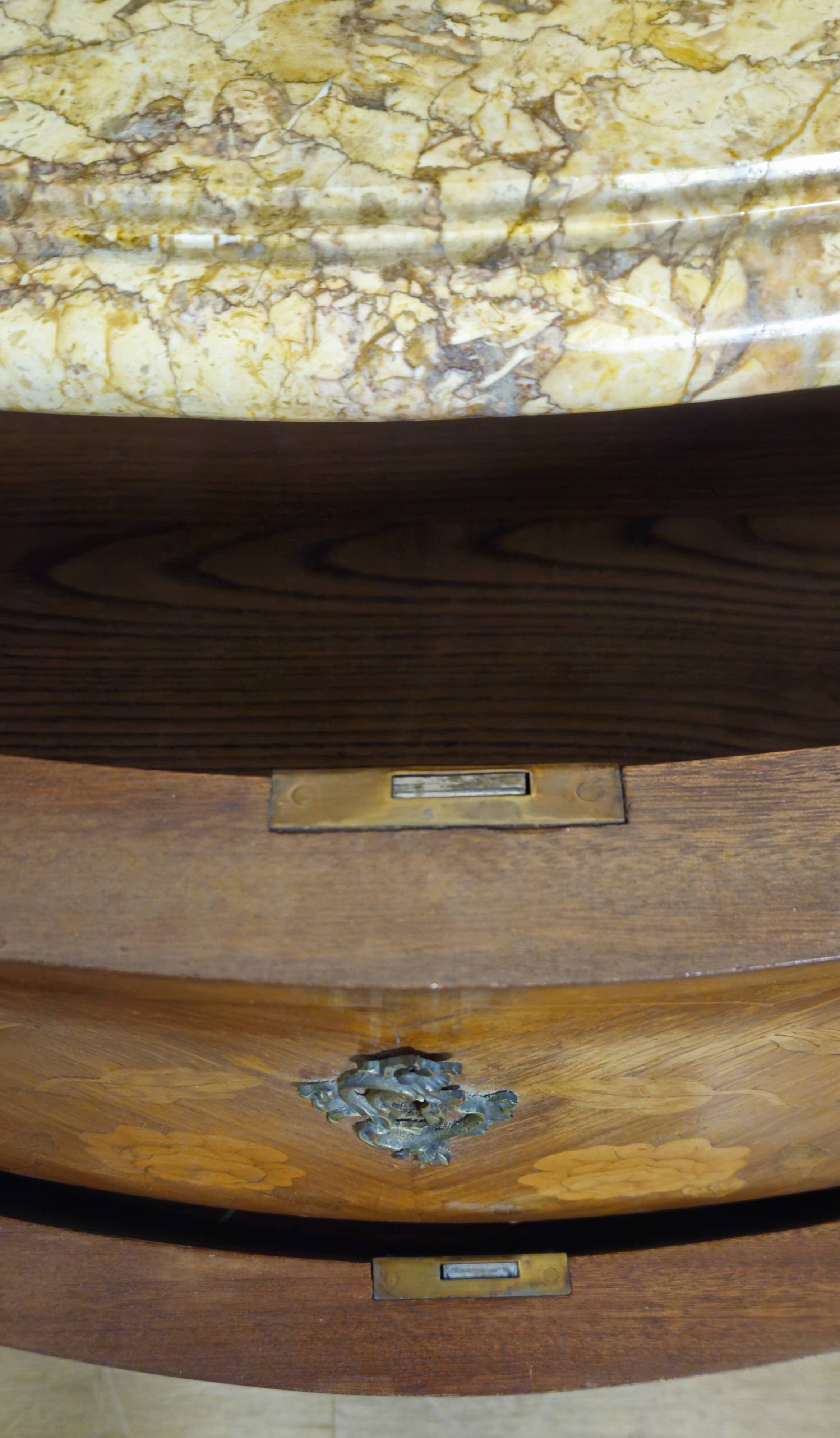 Curved Louis XV style commode with floral marquetry and marble top.