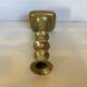 Brass candlestick with a rectangular base.