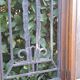 Oak entrance door and its frame and transom, wrought iron gates