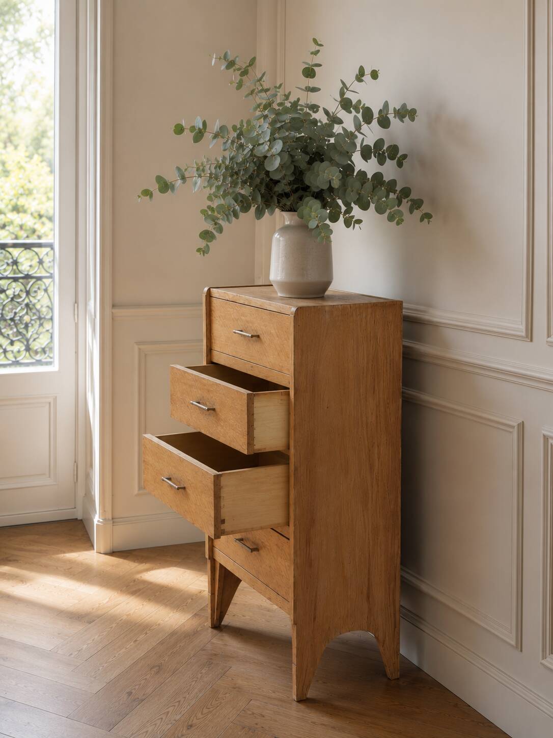 Vintage chest of drawers in raw wood.
