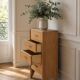 Vintage chest of drawers in raw wood.