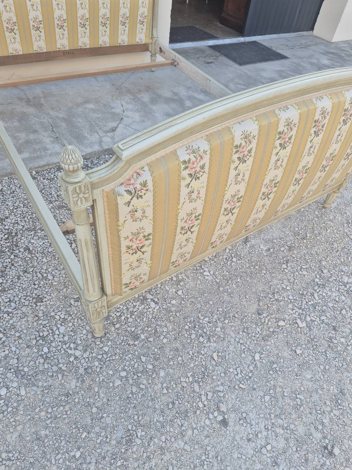 Louis XVI style bed richly decorated in patinated wood.